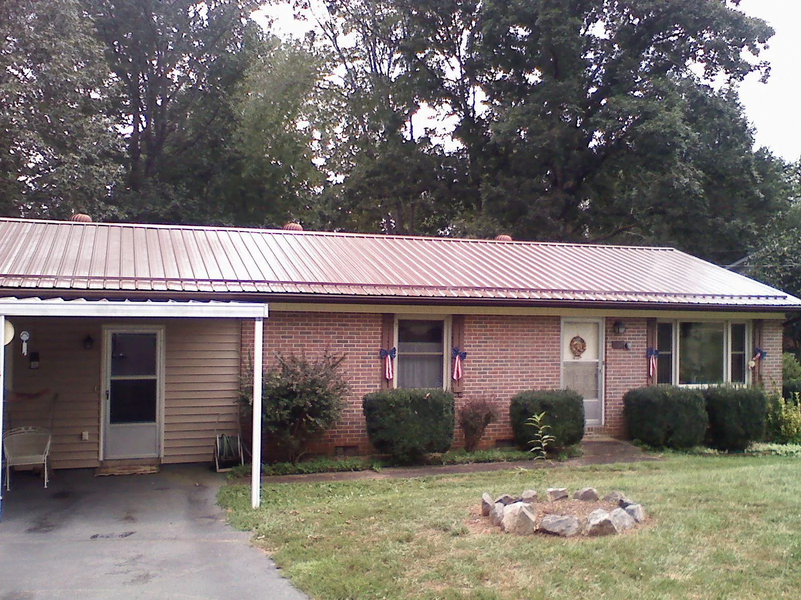 Bronze metal roof and carport on a brick ranch home — Roof Repair work by our crew in Entriken